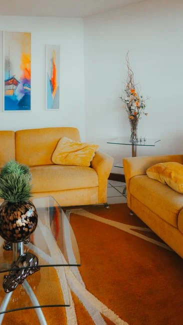 A cleaner operates a vacuum in a sleek indoor space, highlighting cleaning tools and methods.